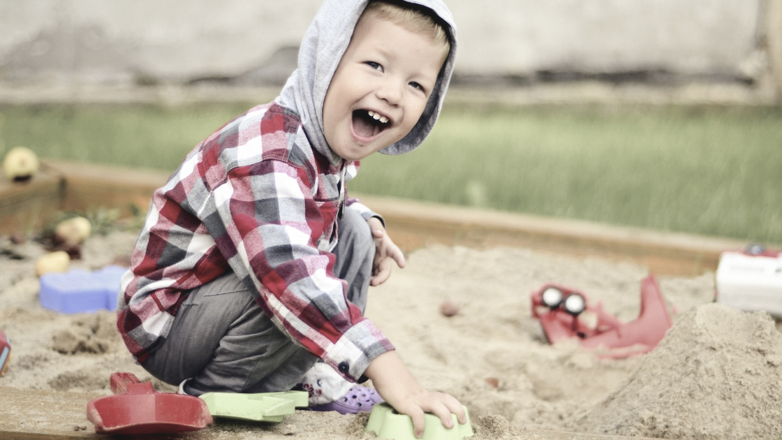 boy playing in sandbox