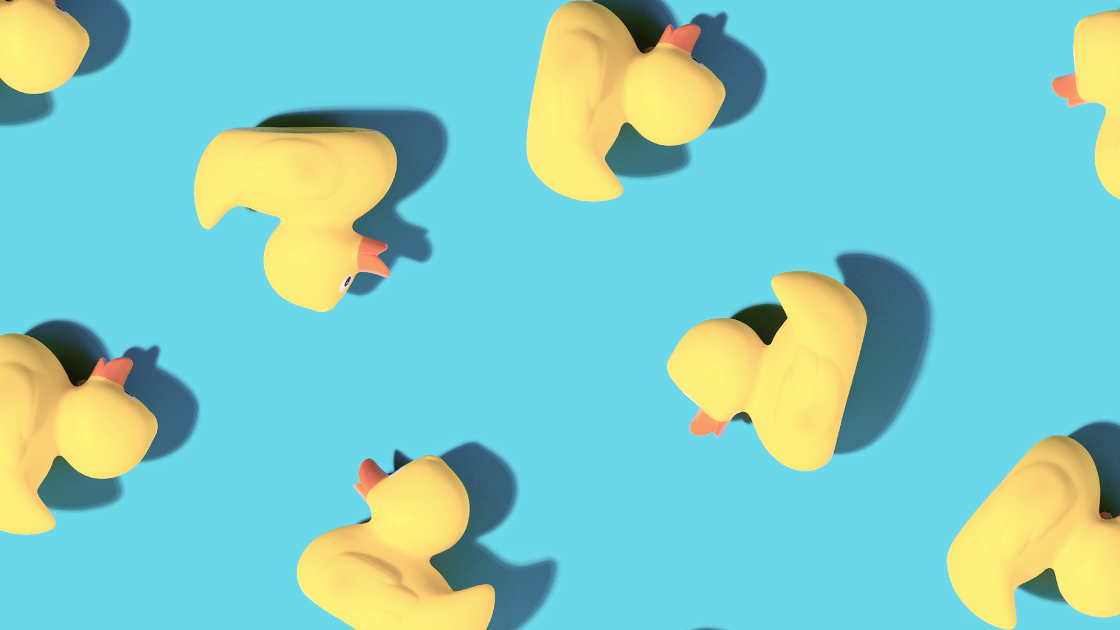 Photo showing multiple yellow rubber duckies on baby-blue background