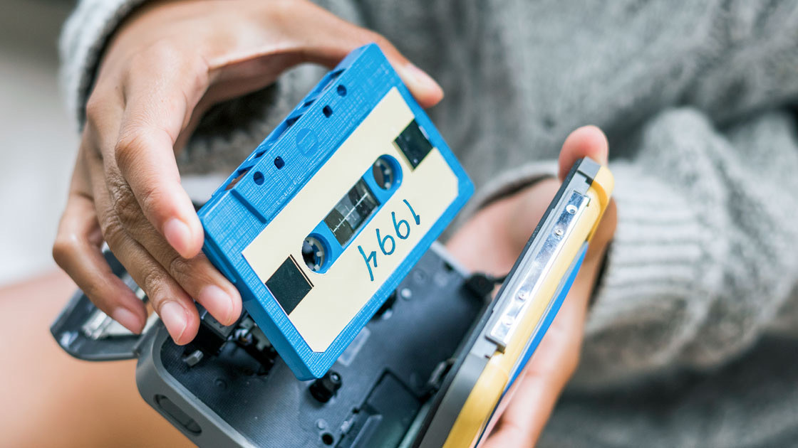 Person loading cassette tape into Sony Walkman
