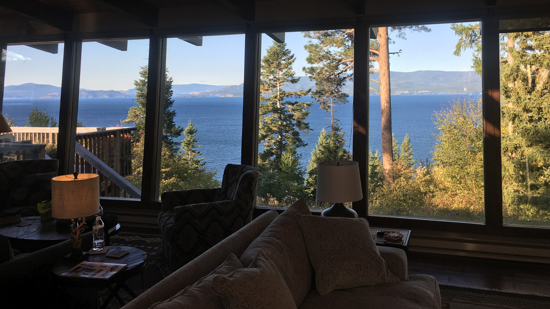 Mark's view in Montana. Beautiful floor to ceiling window views of the lake, mountains and trees.