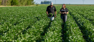 ADM producer and rep walking through a field
