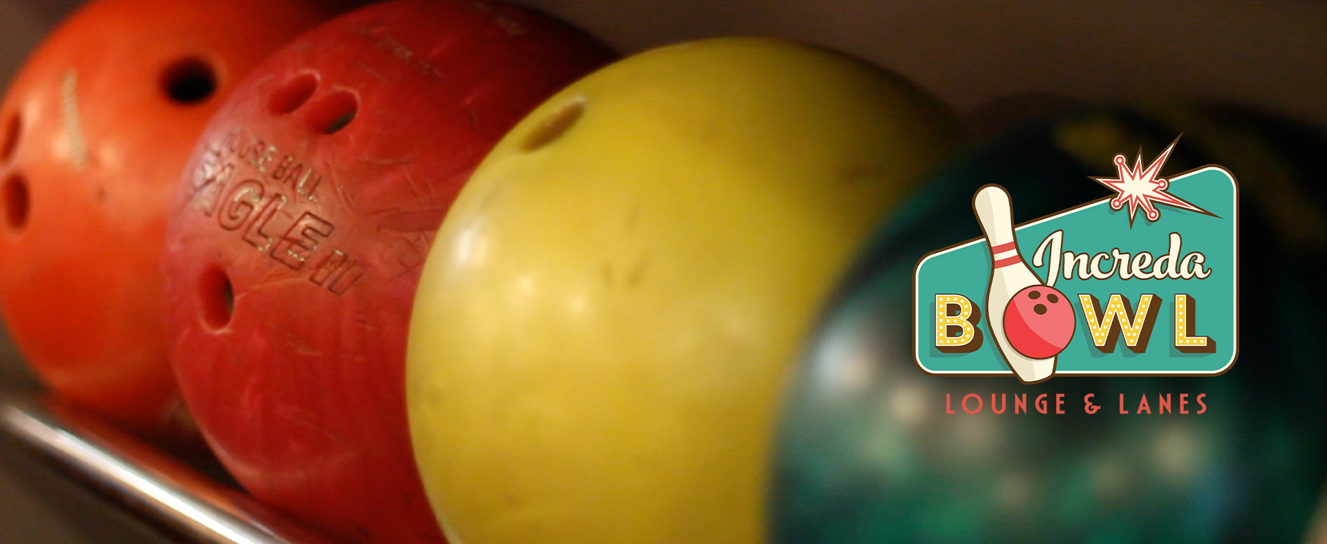 Close up of bowling balls and the IncredaBowl logo