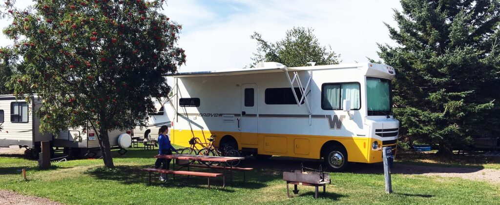 DKY employee at a campsite with the company Winnebago Brave RV