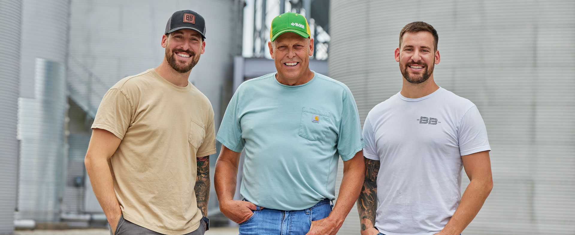 Three men smiling at the camera