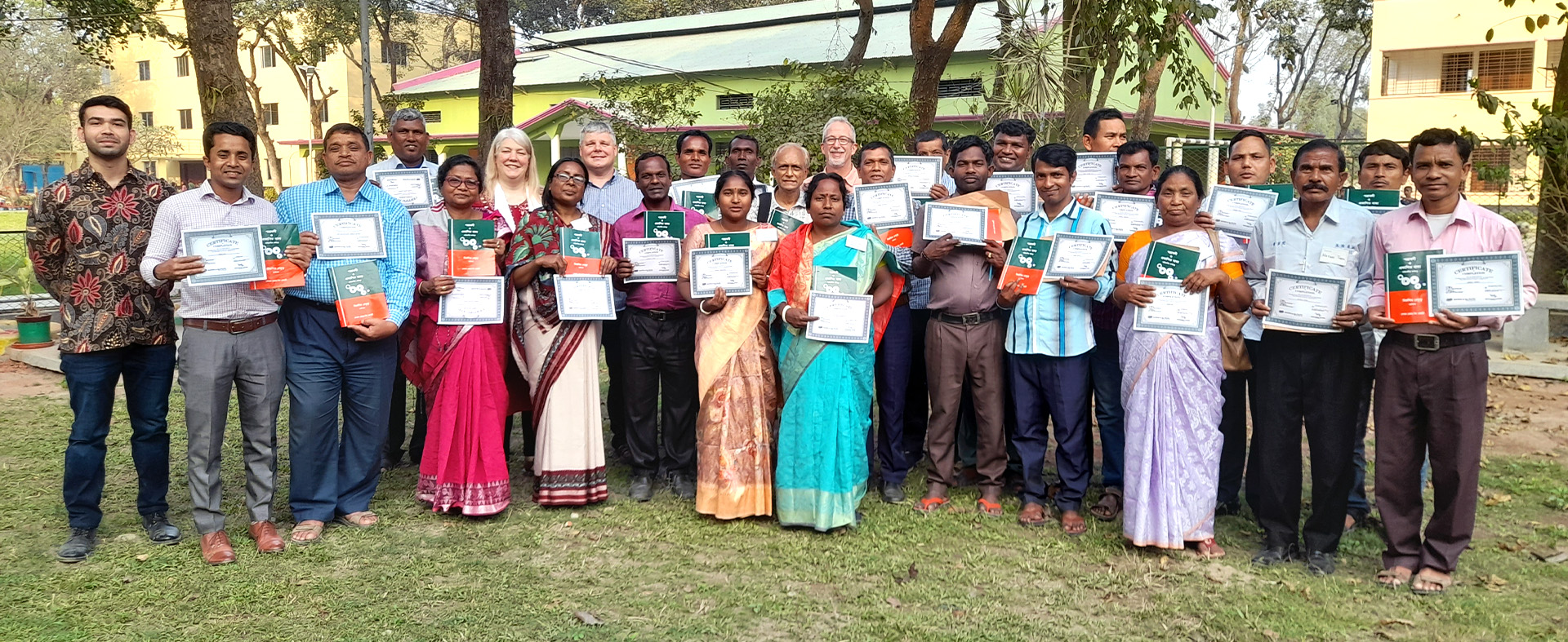group of people holding up certificates